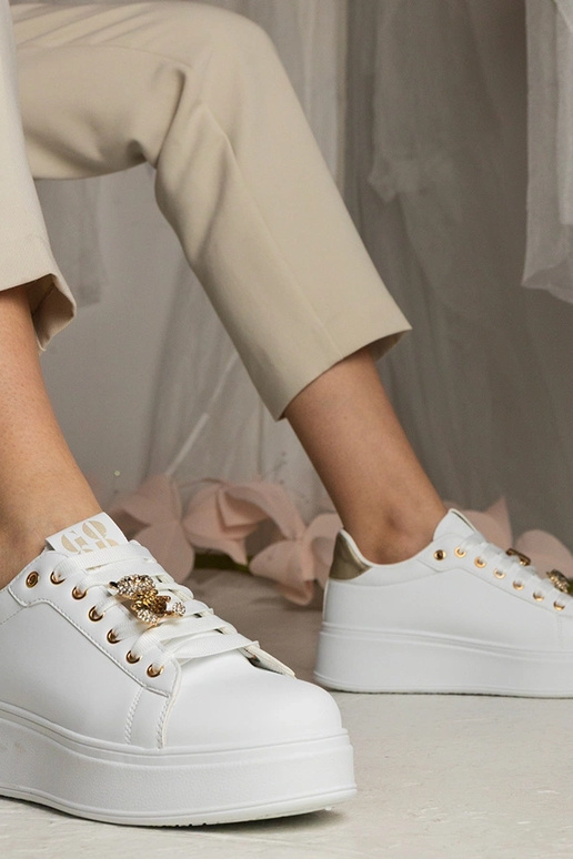 Sneakers bianche e dorate da donna...